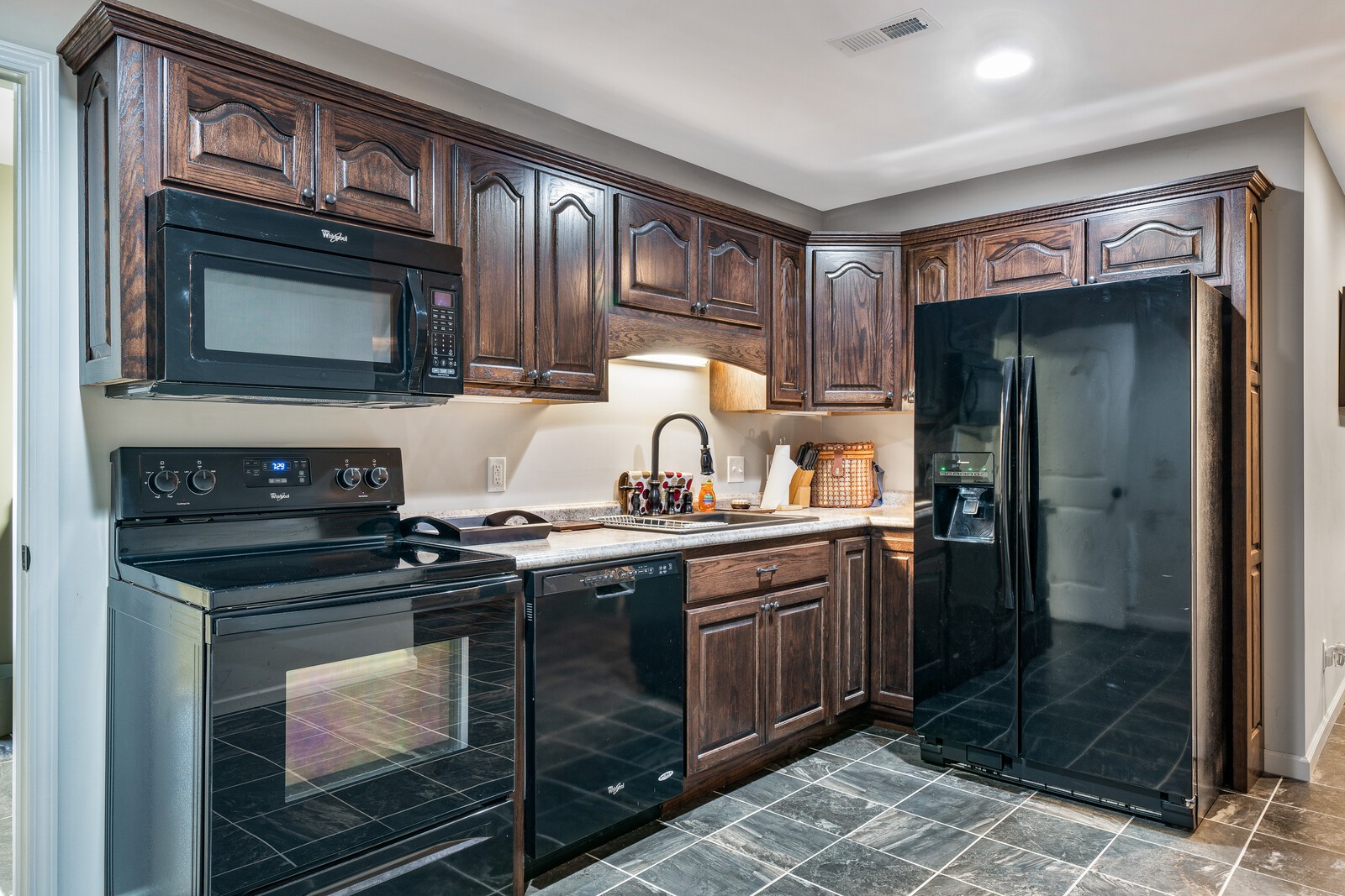 642 Campground Road Livingston, TN 38570 - Photo 19 of 49 a kitchen with stainless steel appliances granite countertop a stove microwave and refrigerator