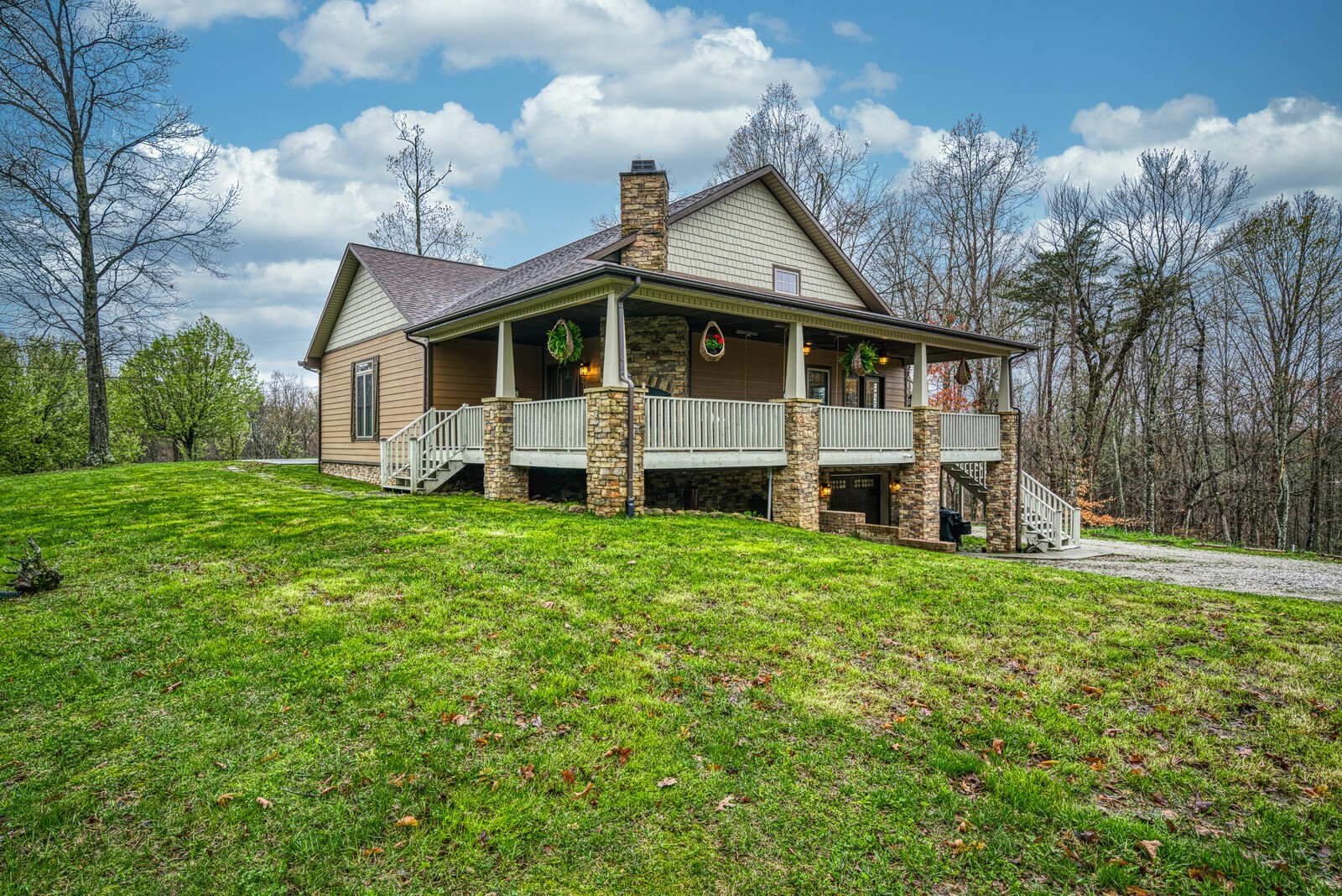 642 Campground Road Livingston, TN 38570 - Photo 29 of 49 a front view of a house with a garden and deck