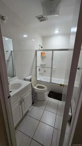 a bathroom with a sink a toilet a mirror and shower