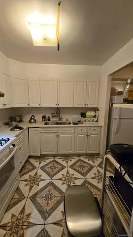 a kitchen with a stove a sink and a refrigerator