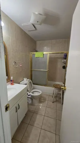 a bathroom with a sink mirror vanity and toilet