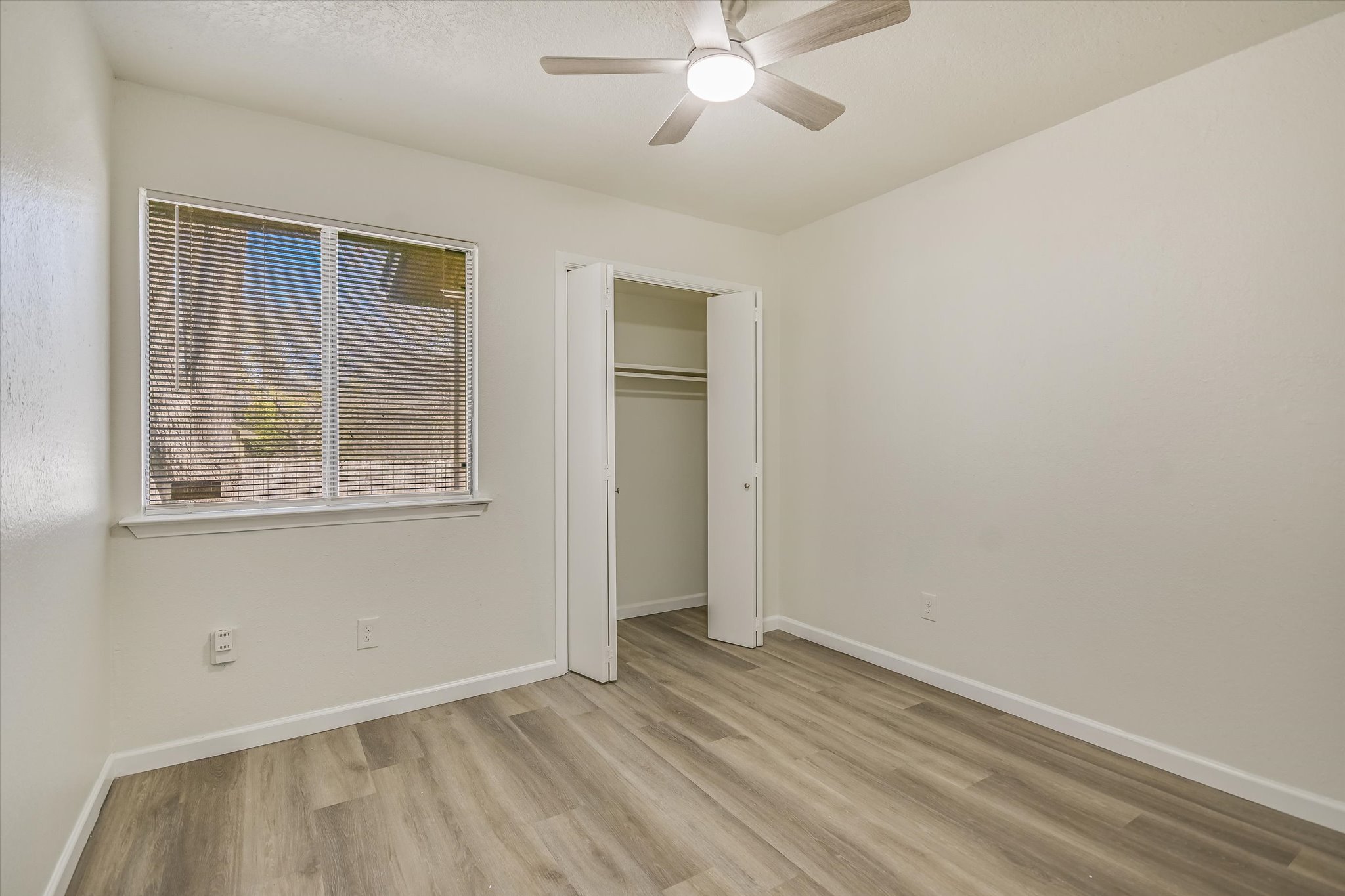 1402 Waterloo Trail, Unit A Austin, TX 78704 - Photo 12 of 15 an empty room with a window
