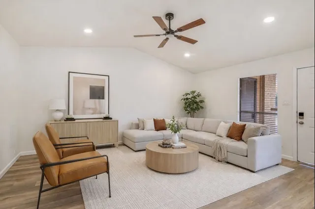 a living room with furniture and a large mirror