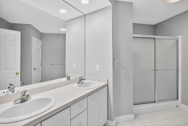 a living room with furniture a fireplace and a floor to ceiling window