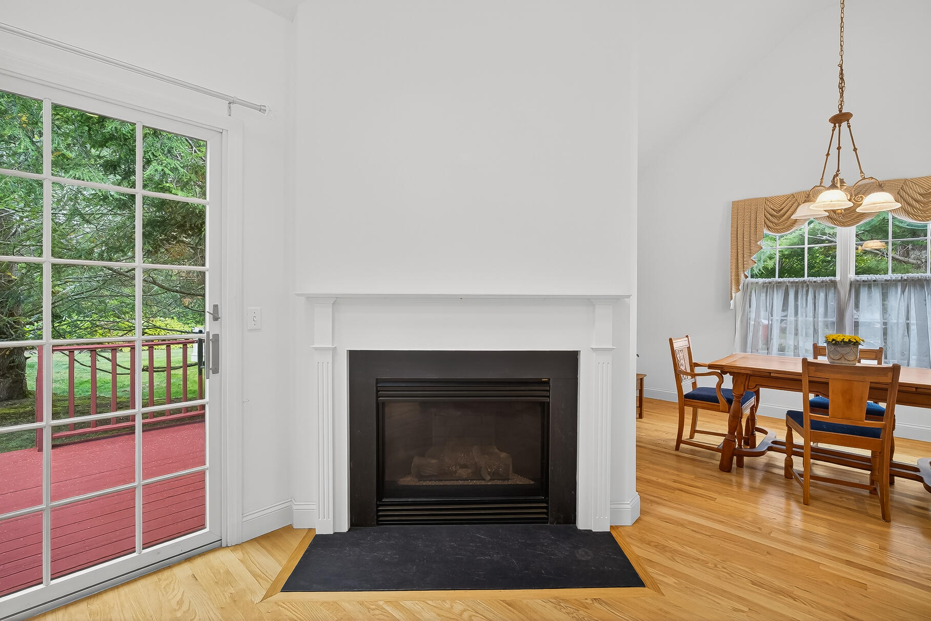 6 Mayfair Court Mashpee, MA 02649 - Photo 35 of 53 a living room with furniture a fireplace and a floor to ceiling window