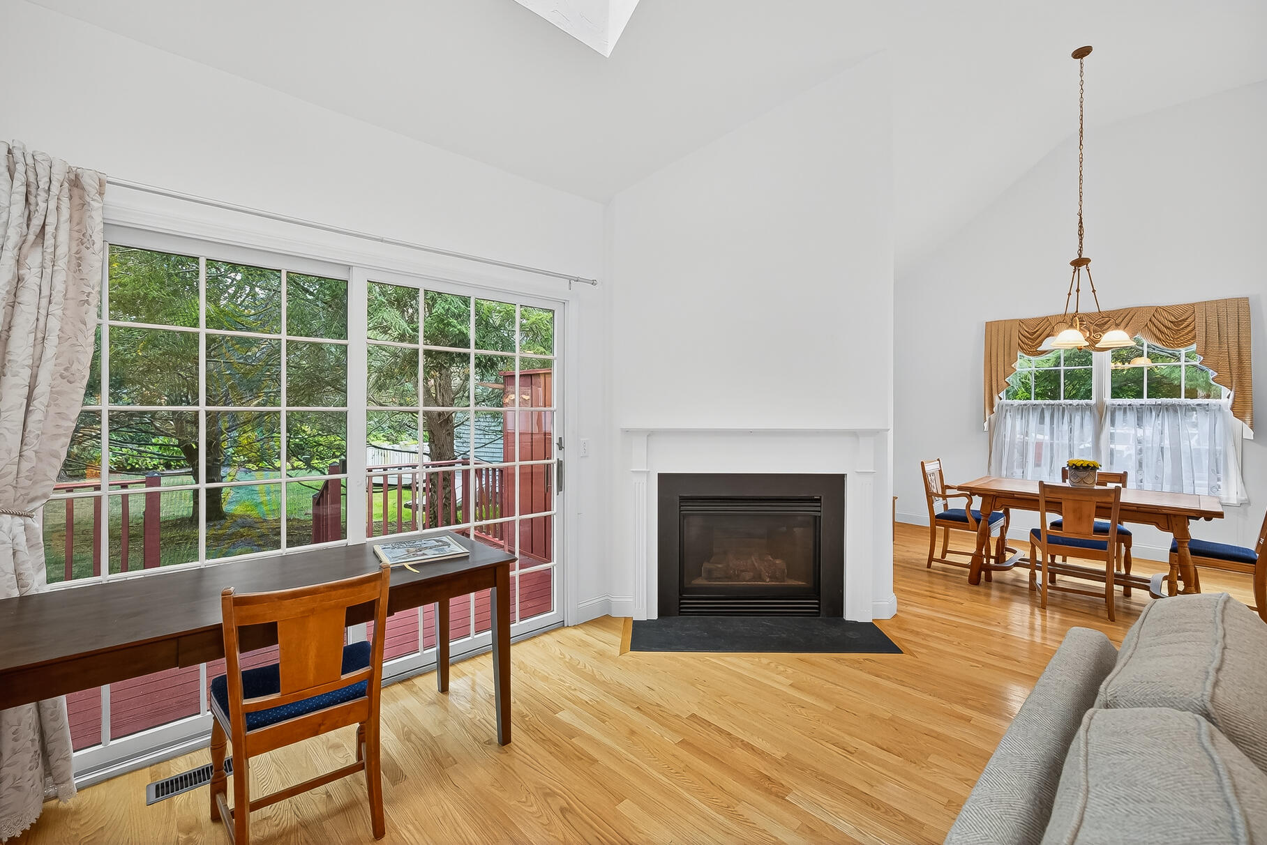 6 Mayfair Court Mashpee, MA 02649 - Photo 36 of 53 a living room with furniture a fireplace and a floor to ceiling window