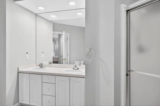 a bedroom with a bed and a lamp