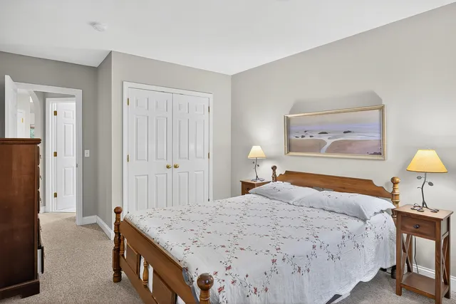 a bedroom with a bed and a lamp