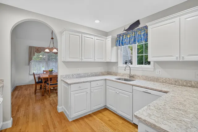 a kitchen with granite countertop a sink white cabinets and a granite counter tops