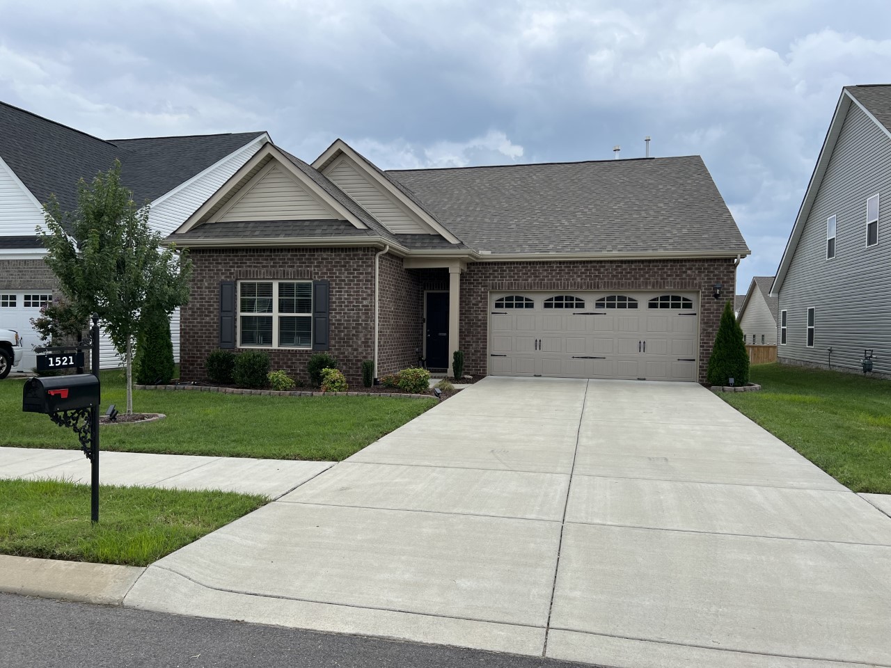 1521 Holton Road Gallatin, TN 37066 - Photo 1 of 2 a front view of a house with a yard and garage