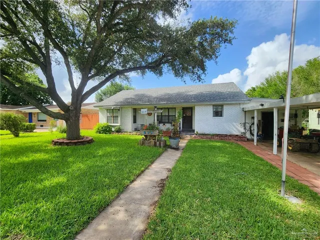 a front view of a house with a yard table and chairs