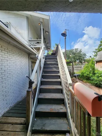 a view of a balcony with wooden floor and fence