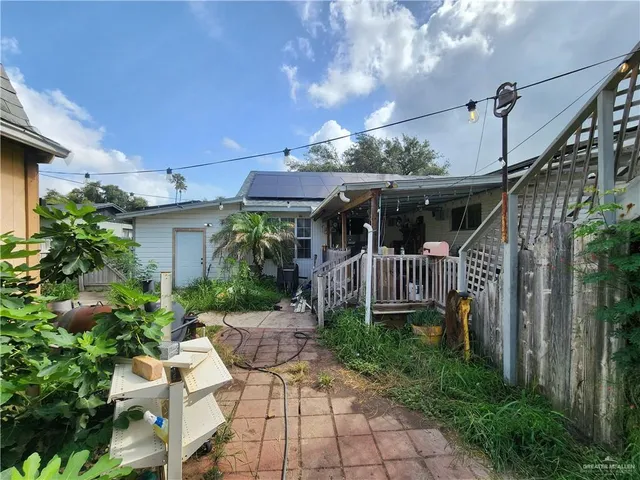 a view of a house with brick walls and a yard