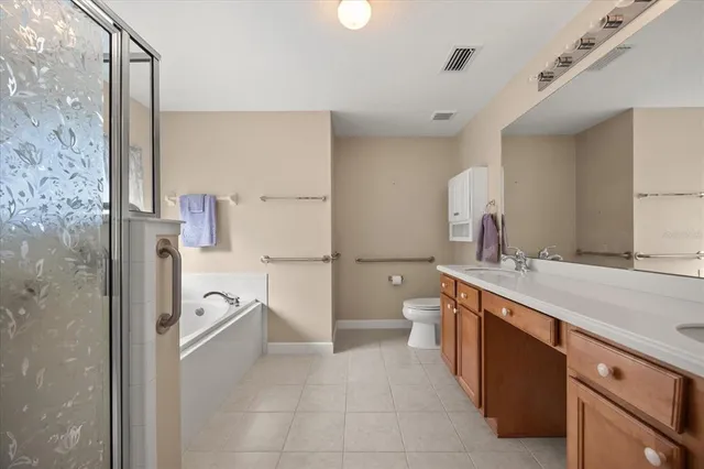 a spacious bathroom with a shower sink and mirror