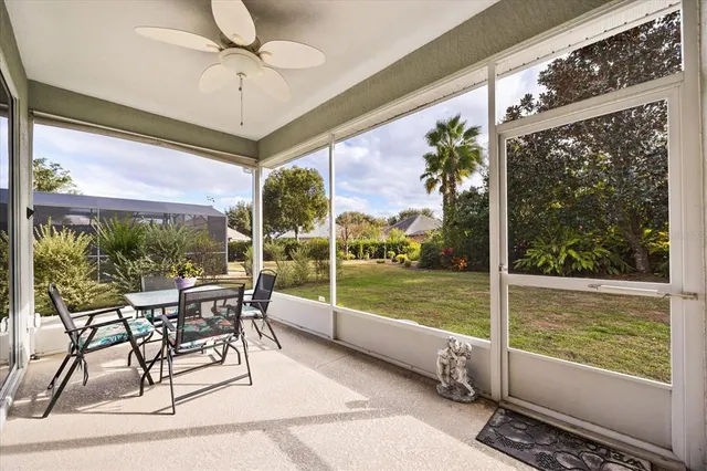 a view of a porch with furniture and a yard