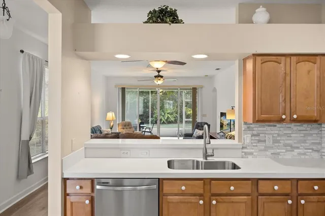a kitchen with stainless steel appliances granite countertop a sink and a refrigerator