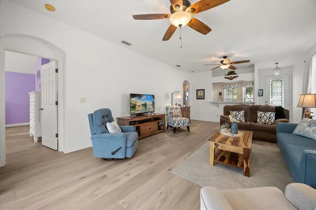 a living room with furniture or couch and a ceiling fan