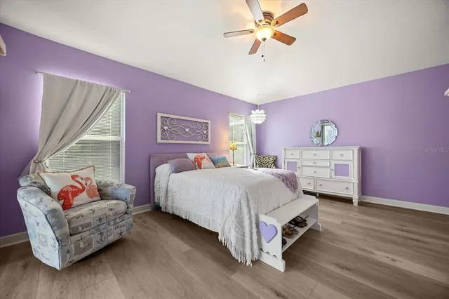 a spacious bedroom with a bed and a chandelier