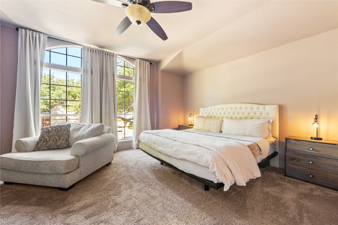1111 Pathfinder Way Round Rock, TX 78665 - Photo 21 of 40 a spacious bedroom with a bed and a couch