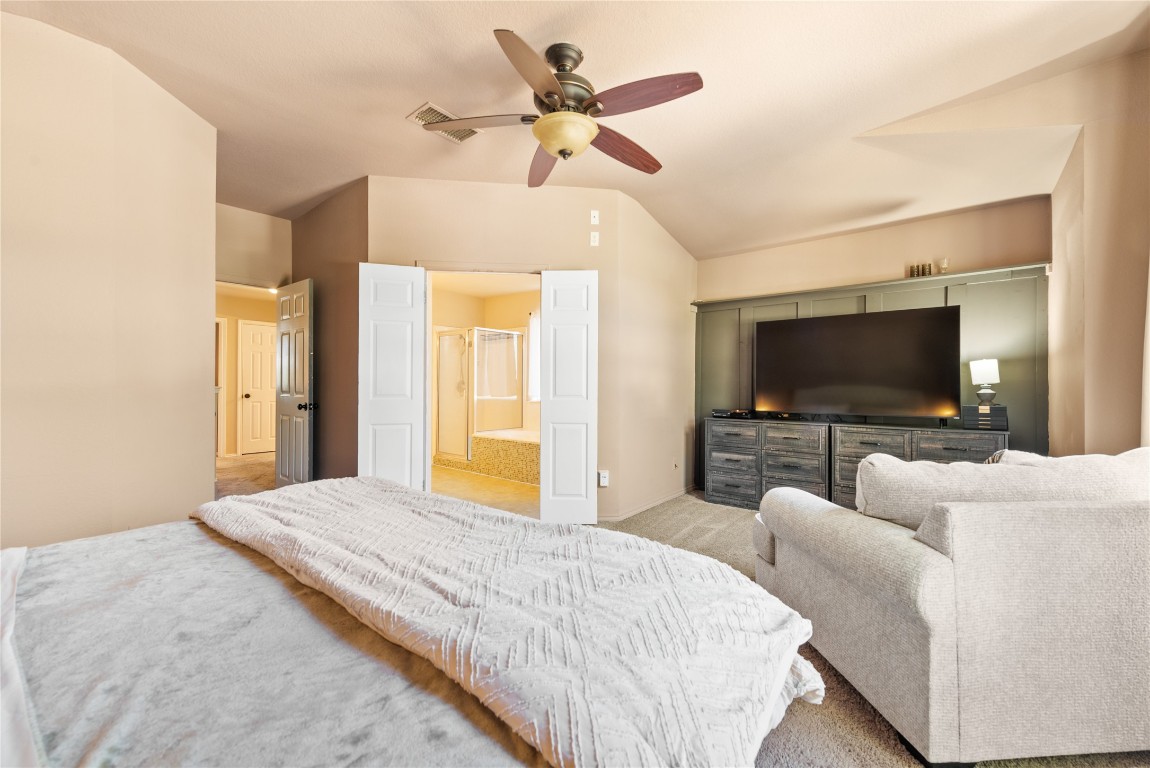 1111 Pathfinder Way Round Rock, TX 78665 - Photo 22 of 40 a bedroom with a bed and a flat screen tv