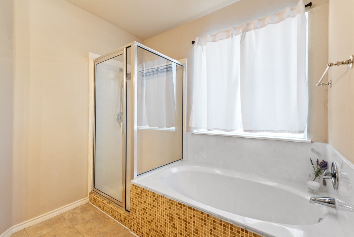 1111 Pathfinder Way Round Rock, TX 78665 - Photo 23 of 40 a bathroom with a tub and shower
