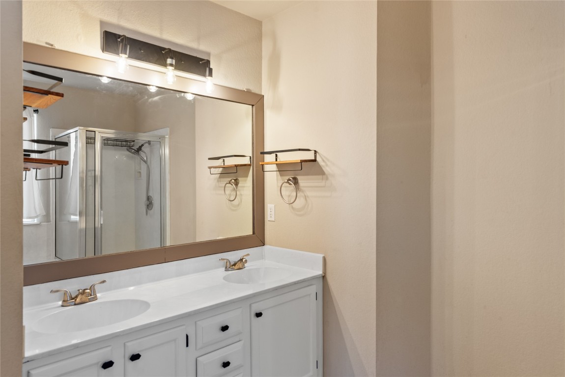 1111 Pathfinder Way Round Rock, TX 78665 - Photo 24 of 40 a bathroom with a double vanity sink and mirror