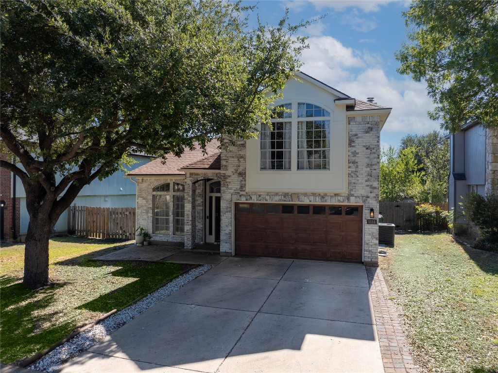 1111 Pathfinder Way Round Rock, TX 78665 - Photo 40 of 40 a front view of a house with a garden and trees