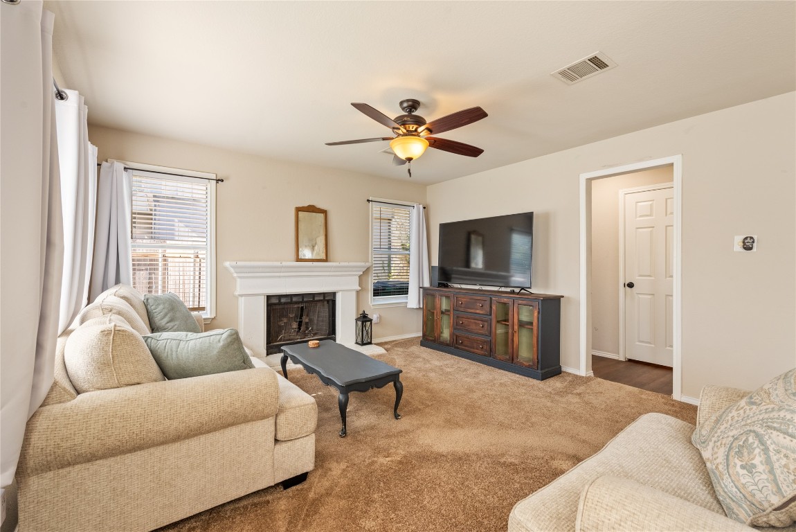 1111 Pathfinder Way Round Rock, TX 78665 - Photo 10 of 40 a living room with furniture a fireplace and a flat screen tv