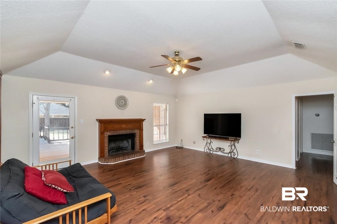 6601 Conde Court Mobile, AL 36695 - Photo 9 of 30 Living room with a fireplace, dark hardwood / wood-style flooring, and a textured ceiling