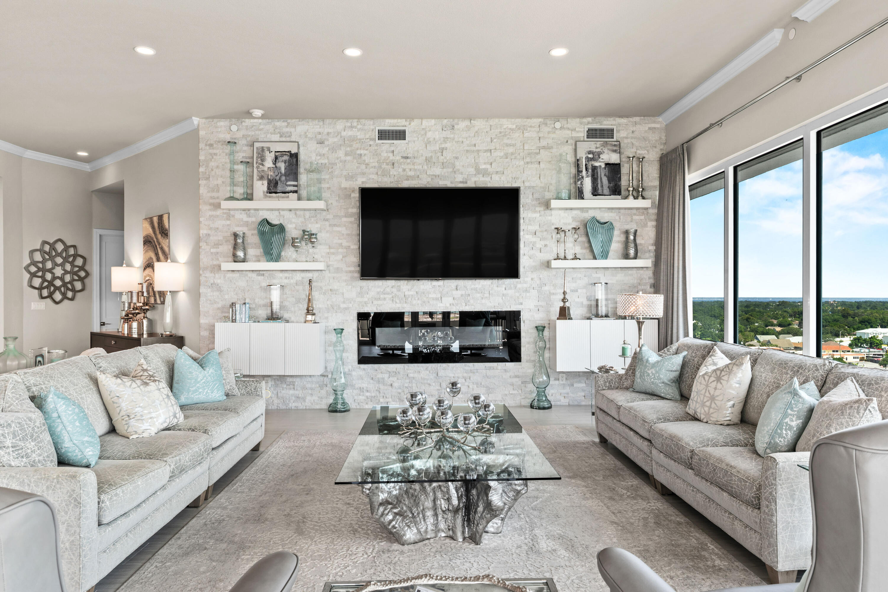 320 Harbor Boulevard, Unit 1201 Destin, FL 32541 - Photo 14 of 86 a living room with furniture a flat screen tv and a fireplace