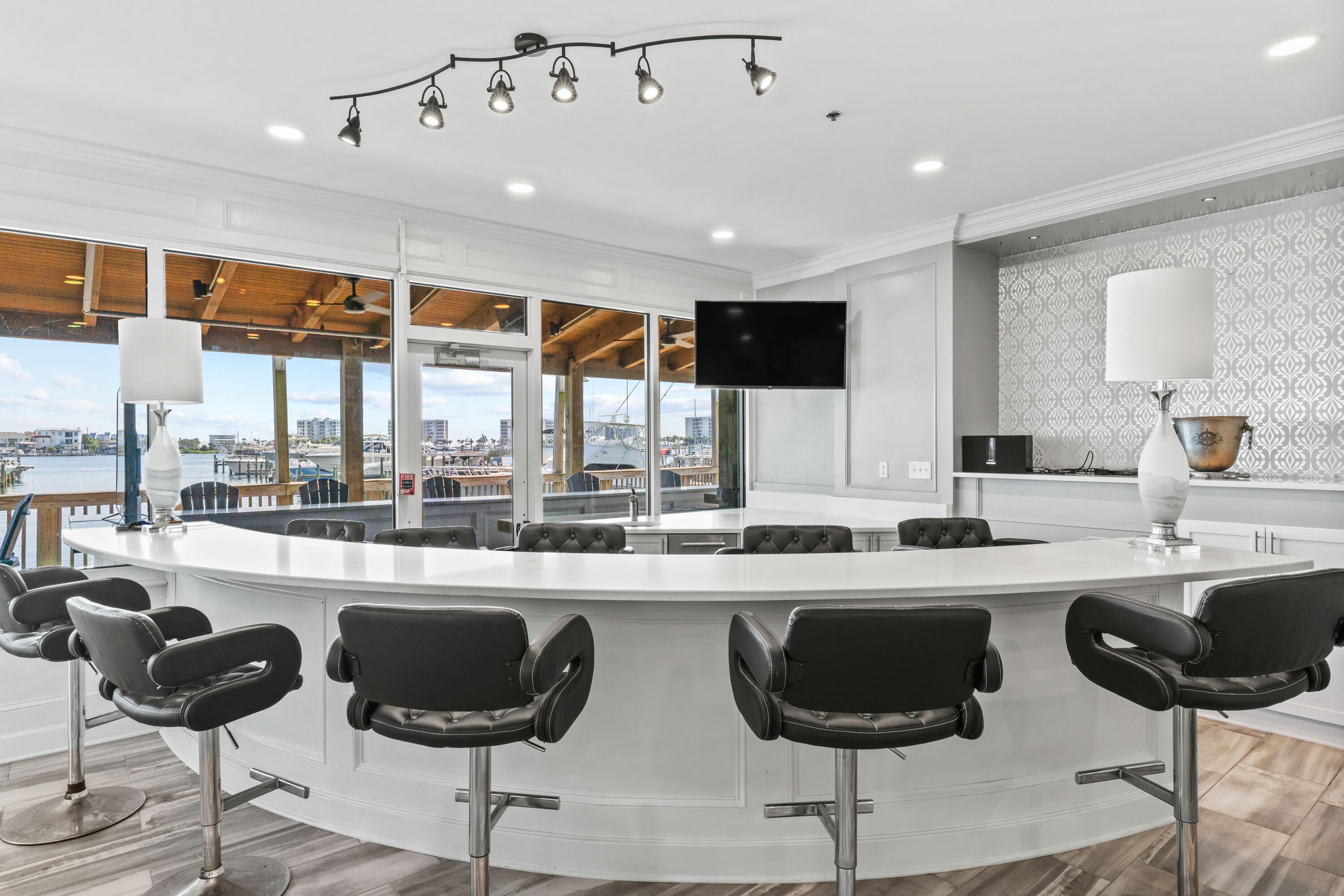 320 Harbor Boulevard, Unit 1201 Destin, FL 32541 - Photo 62 of 86 a kitchen with stainless steel appliances granite countertop a stove a sink a refrigerator white cabinets and chairs with wooden floor