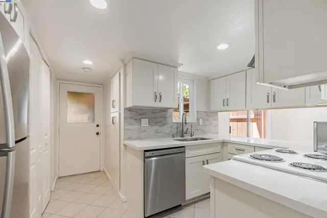a kitchen with a sink stove and cabinets