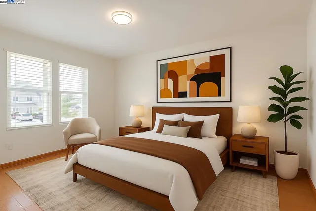 a bedroom with bed and a potted plant