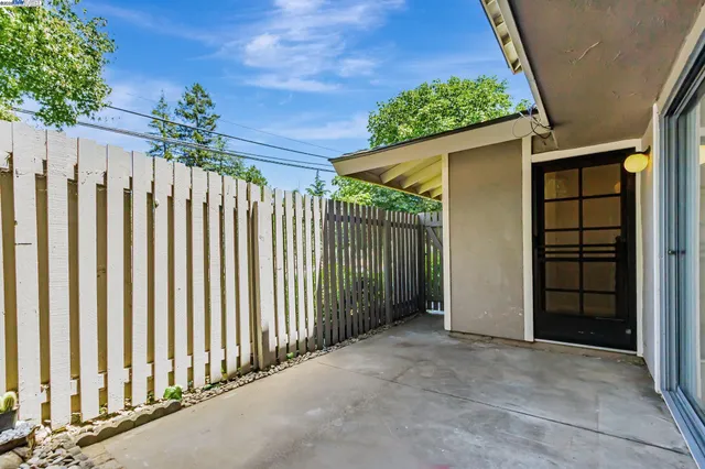 a backyard of a house with yard and outdoor seating