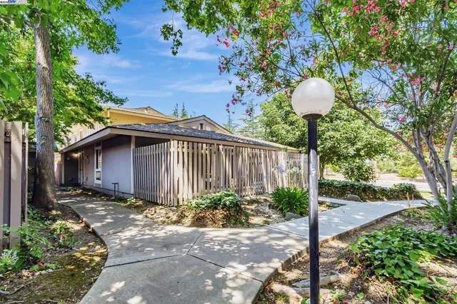 a backyard of a house with yard and outdoor seating