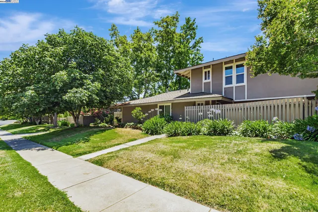 a view of a house with yard and a garden