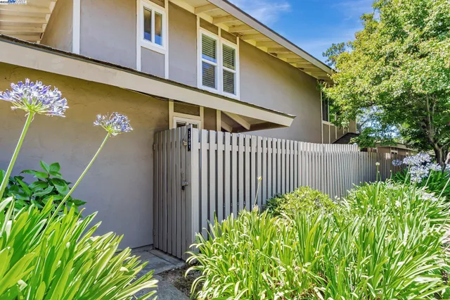 a view of a house with a flower garden