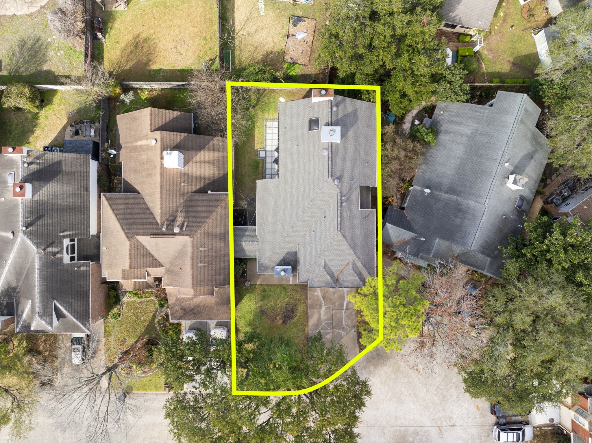 2110 Paso Rello Drive Houston, TX 77077 - Photo 39 of 41 This aerial photo highlights a two-story home outlined in yellow, nestled between two neighboring houses. The property features a spacious backyard with mature trees and a driveway leading to the front. It's situated in a well-established neighborhood, offering a balance of privacy and community.