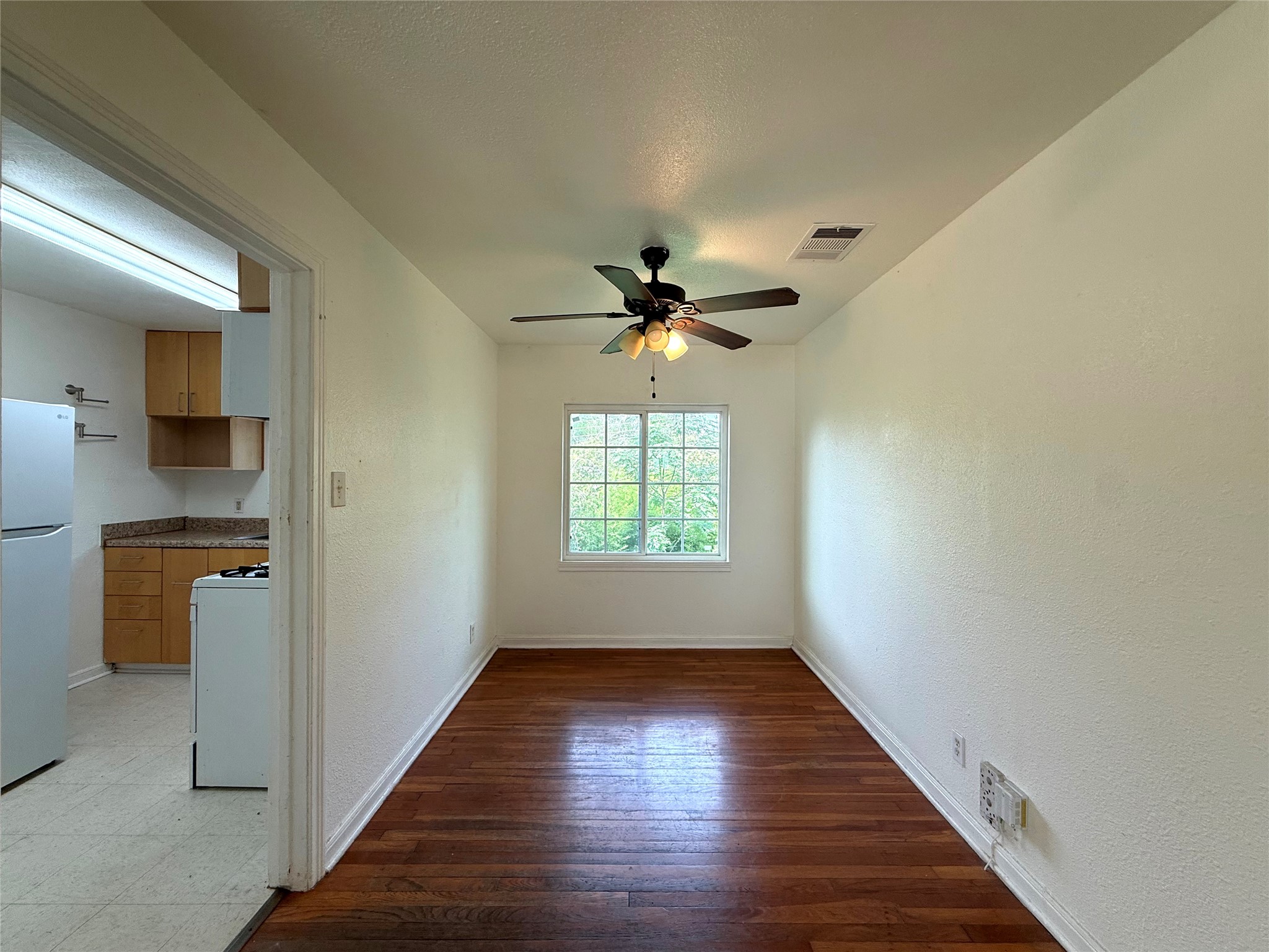 3305 Merrie Lynn Avenue Austin, TX 78722 - Photo 4 of 22 Rich hardwood floors create a welcoming atmosphere in this adaptable living space.