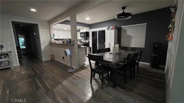 a view of a dining room with furniture and wooden floor