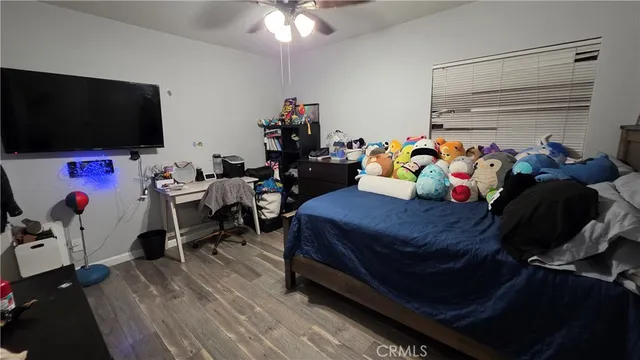 a bedroom with a bed and flat screen tv