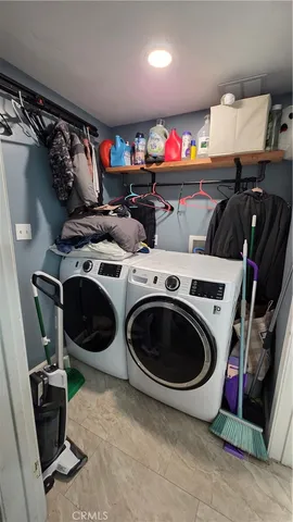 a utility room with dryer washer and closet