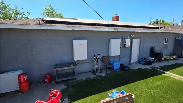 a backyard of a house with table and chairs