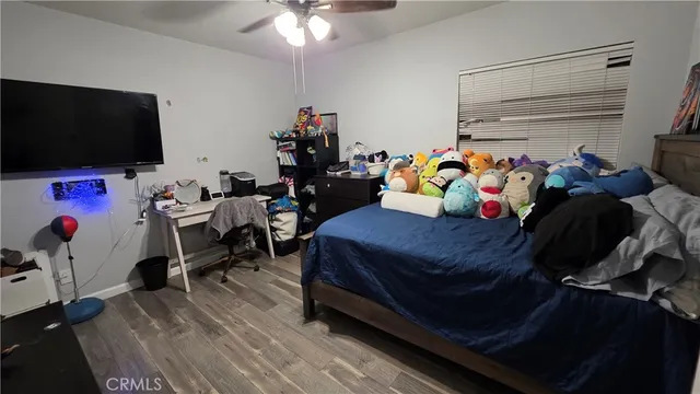 a bedroom with furniture and a flat screen tv
