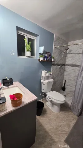 a bathroom with a sink vanity and toilet