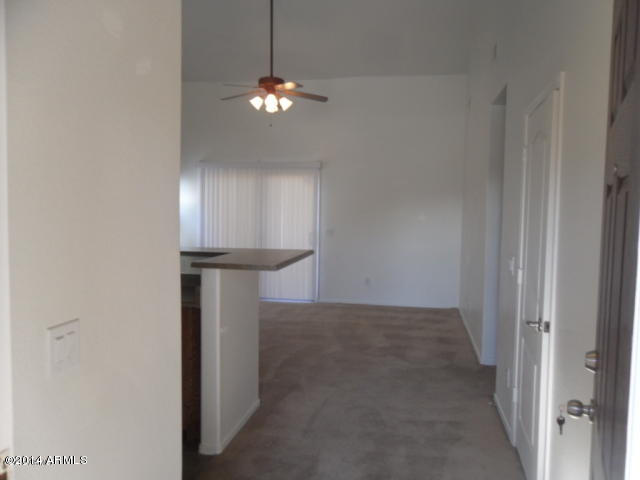4510 West Carson Road Laveen, AZ 85339 - Photo 4 of 9 a view of a hallway with a chandelier