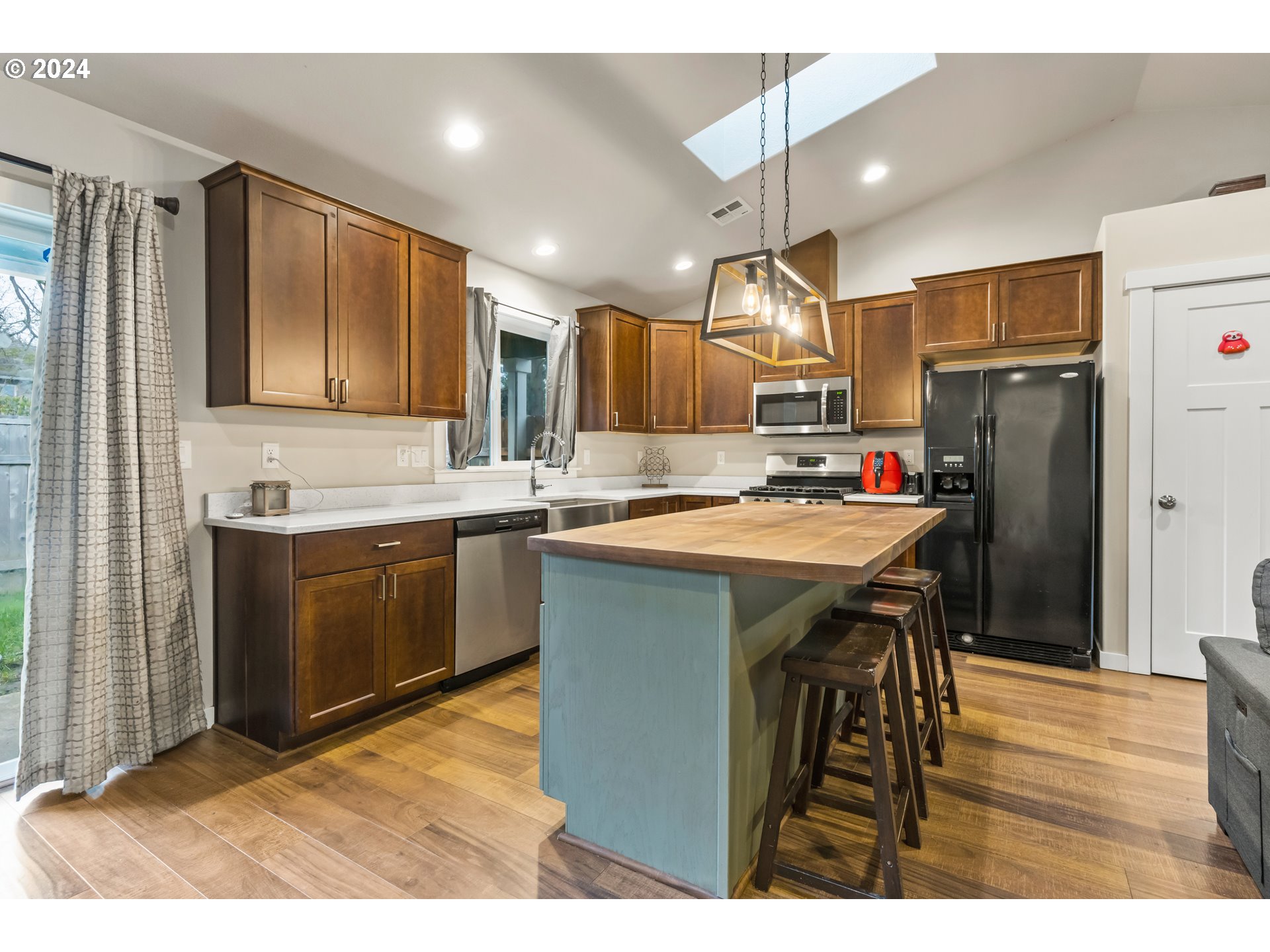 4353 Liberty Road South Salem, OR 97302 - Photo 8 of 25 a kitchen with refrigerator cabinets and wooden floor