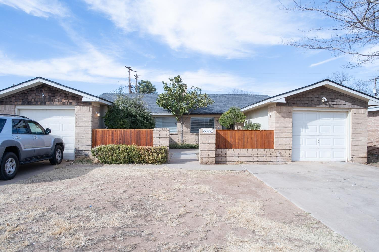 5522 13th Street, Unit A Lubbock, TX 79416 - Photo 1 of 11 a view of a house with a yard and garage