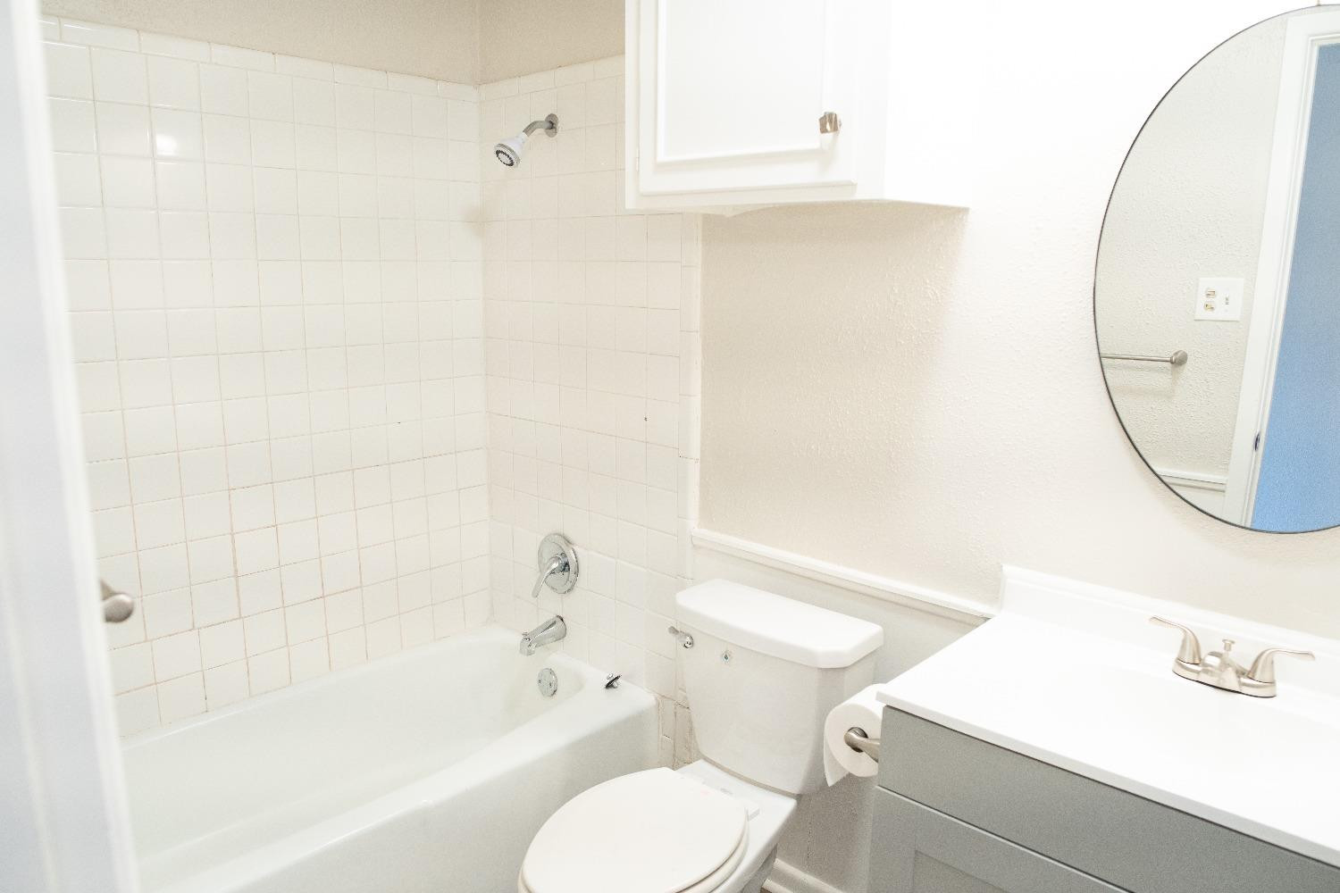 5522 13th Street, Unit A Lubbock, TX 79416 - Photo 11 of 11 a bathroom with a sink a toilet and a bathtub