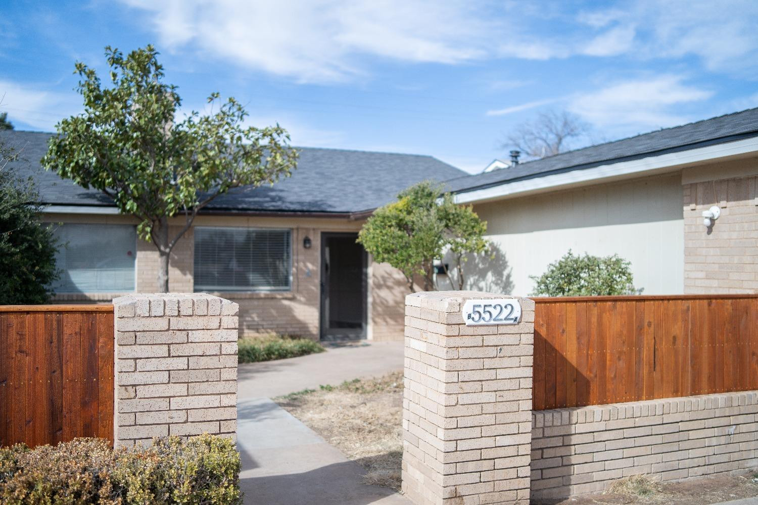 5522 13th Street, Unit A Lubbock, TX 79416 - Photo 2 of 11 a front view of a house with a garden